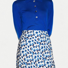 Model wearing Jigsaw blue long-sleeve polo dress with blue and white leopard print skirt section and button neckline detail.