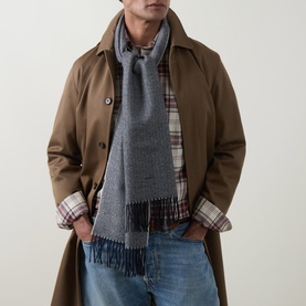 Model with Gant Evening Blue wool scarf with fringe detail, styled with tan trench coat and plaid shirt