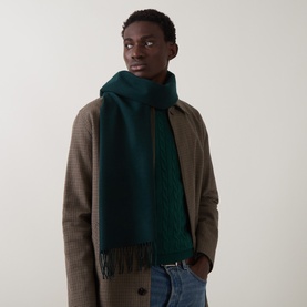 Model with Gant tartan green wool scarf with fringe ends, styled with a brown houndstooth coat and jeans