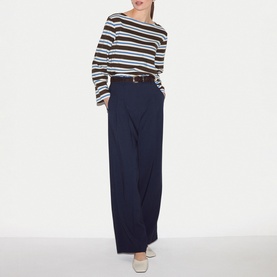 Model wearing Jigsaw brown striped long sleeve top with wide-leg navy trousers and tan belt
