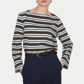 Model wearing Jigsaw brown striped long sleeve top with boat neck, styled with navy trousers and dark leather belt.
