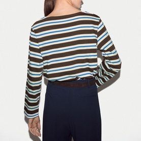 Model wearing Jigsaw brown striped long-sleeve top, back view, styled with navy wide-leg trousers
