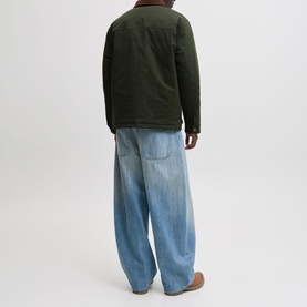Model wearing Jack & Jones Norrebro Padded Barn Jacket in Rosin, back view, styled with light wash wide-leg jeans.