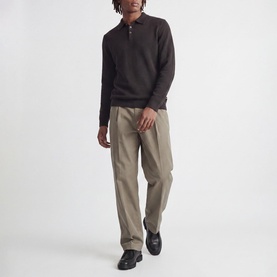 Model wearing Jack & Jones Riley Knitted Polo Shirt in Ganache, styled with taupe wide-leg trousers and black loafers