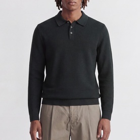 Model wearing Jack & Jones Riley Logo Knitted Polo Shirt in Scarab, featuring polo collar, quarter-button fastening and long sleeves, styled with