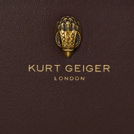Kurt Geiger London brown leather small wallet, close-up of gold eagle-crest hardware clasp detail