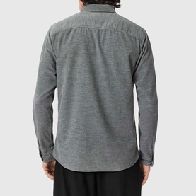 Model wearing All Saints light grey long-sleeve shirt, rear view, with subtle texture and curved hem.