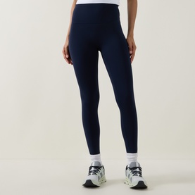 Model wearing Lululemon True Navy leggings, styled with white ankle socks and grey and white trainers