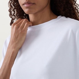 Model wearing Lululemon All Yours T-Shirt in white, close-up of crew neckline and relaxed fit fabric detail.