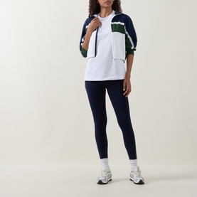 Model wearing Lululemon All Yours T-Shirt in white, styled with navy colour-block zip jacket and navy leggings