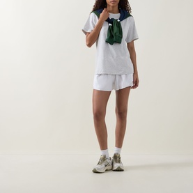 Model wearing Lululemon All Yours T-Shirt in Heathered Core Ultra Light Grey, styled with matching shorts, green scarf and trainers.