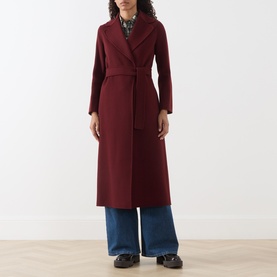 Model wearing Max Mara S bordeaux wool wrap coat with belt, styled with blue wide-leg trousers and printed blouse