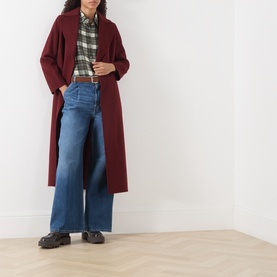 Model wearing Max Mara S bordeaux wool coat, styled with green plaid shirt, wide-leg blue jeans and black chunky loafers