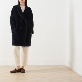 Model wearing Max Mara S Midnight Blue alpaca-wool double-breasted coat, styled with cream trousers and brown loafers