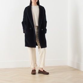 Model wearing Max Mara S Midnight Blue alpaca-wool blend coat, styled with cream jumper, wide-leg trousers and brown loafers.