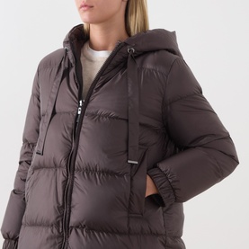Model wearing Max Mara Cube dark brown hooded puffer jacket with zip fastening, quilted panels and side pockets, styled with cream top.