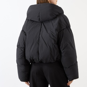 Model wearing Max Mara Sportmax black cropped puffer jacket, rear view, oversized collar, quilted panelling detail.