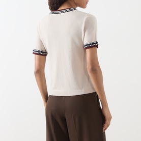 Model wearing Max Mara S Carina Contrast Trim Sweater in Albino with contrast trim detailing, paired with brown wide-leg trousers.
