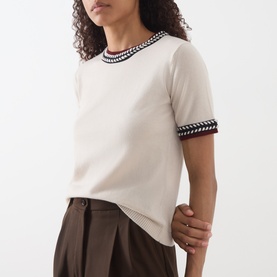 Model wearing Max Mara S Carina Contrast Trim Sweater in Albino with navy contrast trim at neckline and cuffs, styled with dark brown trousers.