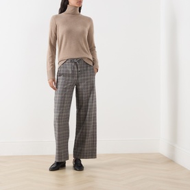 Model wearing Max Mara S Clay Melange wool turtleneck jumper, styled with grey check wide-leg trousers and black loafers.