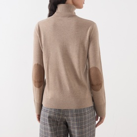 Model wearing Max Mara S Clay Melange wool turtleneck with contrast suede elbow patches, shown from the back, styled with checked trousers
