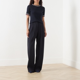 Model wearing Max Mara S Carina Contrast Trim Sweater in ultramarine, short sleeves, contrast trim, styled with wide-leg trousers.