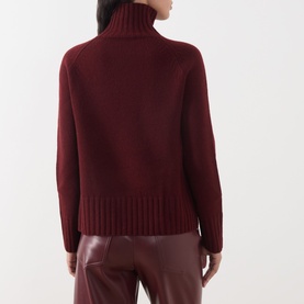 Model wearing Max Mara S Mantova Turtleneck Sweater in bordeaux wool-cashmere, back view, with chunky ribbed trims and matching trousers.