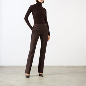 Model wearing Max Mara Sportmax chocolate wool turtleneck top, styled with matching brown flared trousers and black heels.
