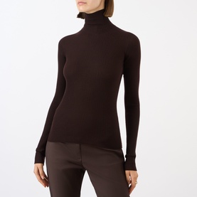 Model wearing Max Mara Sportmax chocolate wool ribbed turtleneck top with long sleeves, styled with brown wide-leg trousers.