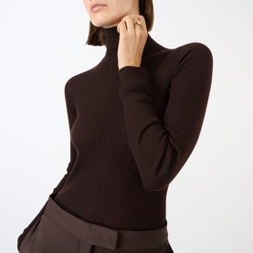 Model wearing Max Mara Sportmax chocolate ribbed wool turtleneck top, styled with brown tailored trousers