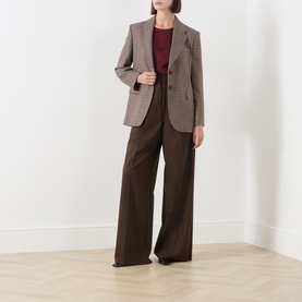 Model wearing Max Mara S Rebecca Solid T-Shirt in Bordeaux, styled with a brown check blazer and wide-leg brown trousers.