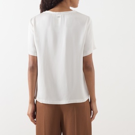 Model wearing Max Mara S ivory short-sleeve top, back view, with brown wide-leg trousers. Relaxed fit, acetate-viscose blend.
