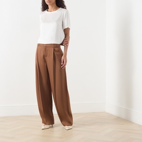 Model wearing Max Mara S ivory acetate-viscose top, styled with wide-leg brown trousers and cream heels.