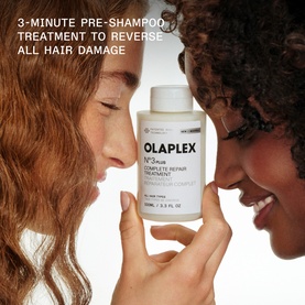 Two models facing each other holding Olaplex N&deg;.3 Plus Complete Repair Treatment 100ml bottle, with text highlighting 3-minute pre-shampoo treatment