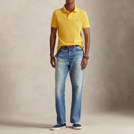 Model wearing Ralph Lauren Yellow Fin Regular Polo with light wash jeans and navy canvas shoes.