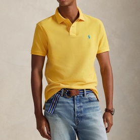 Model wearing Ralph Lauren Regular Polo in Yellow Fin, styled with light wash jeans and a striped belt