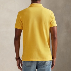 Model wearing Ralph Lauren Regular Polo in Yellow Fin, rear view, styled with light blue jeans
