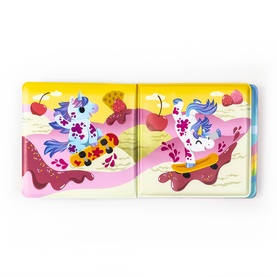 Tiger Tribe multi-coloured children's book shown open, featuring vibrant illustrated unicorns on skateboards with cherries and pink swirls