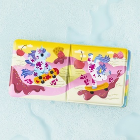 Tiger Tribe children's book open spread showing colourful unicorn illustrations in pink, yellow and blue scenes with cherries and sweets