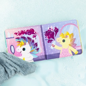 Tiger Tribe multi-coloured unicorn bath book open showing two illustrated unicorn characters on pink and purple pages