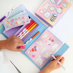 Tiger Tribe arts and crafts set in multi, shown in use with sticker sheets, felt-tip pens, and a spiral notebook featuring cute llama designs