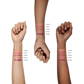Model with Victoria Beckham Blusher shade swatches on three skin tones, showing Fresco, Fiore, Sienna, Rossa and Rubino shades.