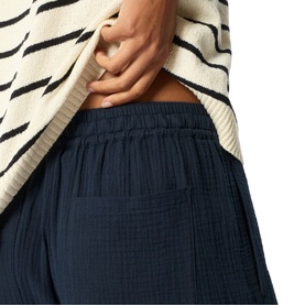 Model wearing Whistles blue wide-leg trousers with elasticated waist in textured fabric, styled with a striped cream knit top.