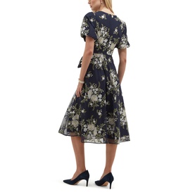 Model wearing Hobbs midnight ivory floral midi dress with flutter sleeves, V-neck, and full skirt, styled with black heels