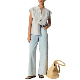 Model wearing Whistles white sleeveless button-front top with wide-leg light blue jeans, black sandals, and a woven tote bag.