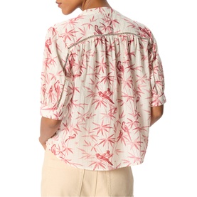Model wearing Whistles pink tropical flamingo print blouse with rolled sleeves, back view, styled with cream trousers