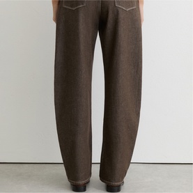Model wearing Reiss brown wide-leg trousers with contrast stitching detail, rear view, styled with dark shoes.