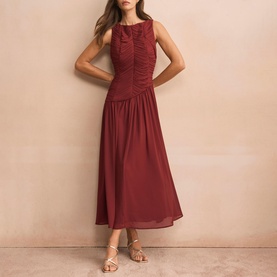 Model wearing burgundy sleeveless midi dress with ruched bodice and full skirt, styled with strappy gold sandals