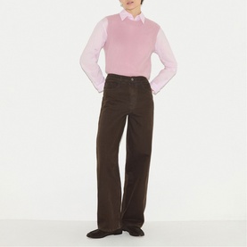 Model wearing Jigsaw pink knitted vest over white collared shirt, styled with wide-leg brown corduroy trousers