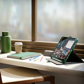 Cygnett green tablet folio case propped open on desk, styled with notebook, pens, and coffee cup by a window
